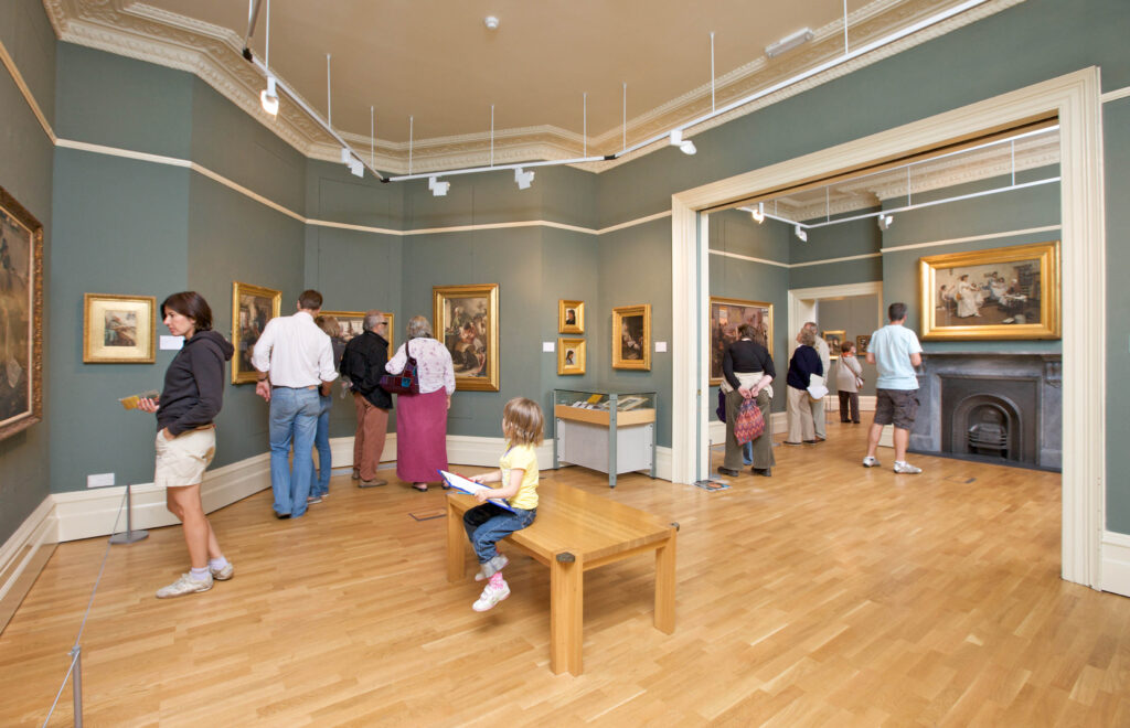 Visitors to Penlee House Gallery & Museum enjoying the artworks on display