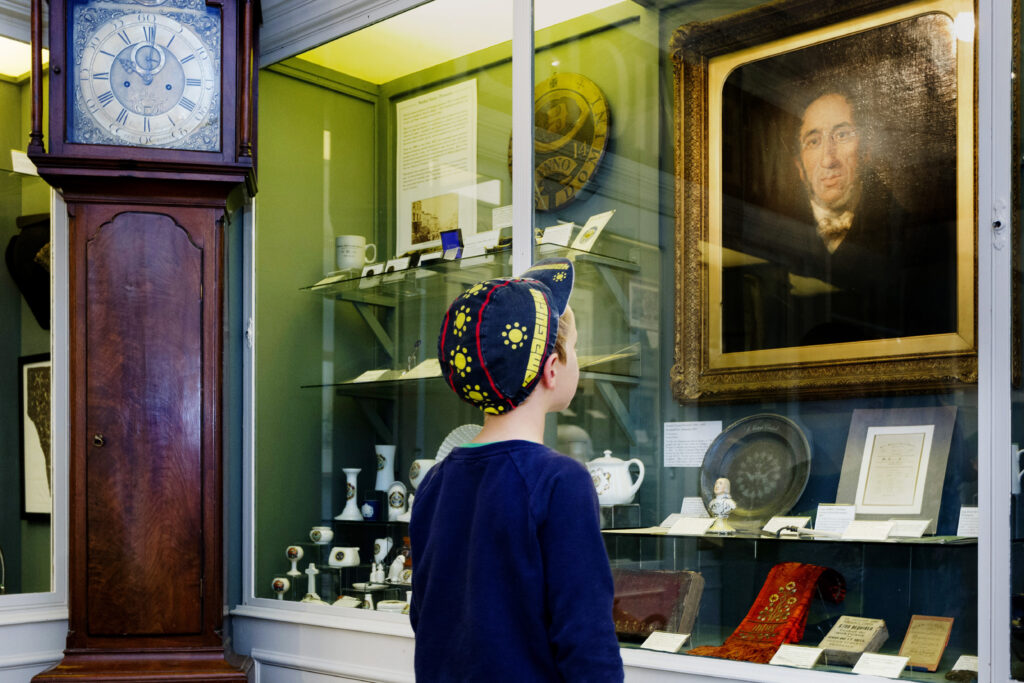 A young boy exploring Penlee House Gallery & Museum's social history displays