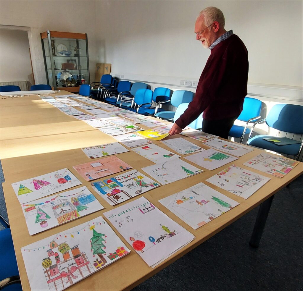 The Mayor of Penzance judges the childrens' Christmas Card design entries for 2022