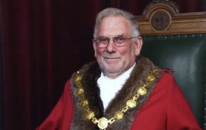 Former Mayor, Cllr Roy Mann, sat on the Mayor's Chair in full civic regalia