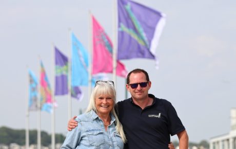 Artist Stevie McCrindle and Vaughan from Sailflags in front of the new flags on the prom